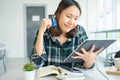 Confused portraitÃÂ young woman holding credit cards having problem online payment with credit card making rejected unsecure online Royalty Free Stock Photo